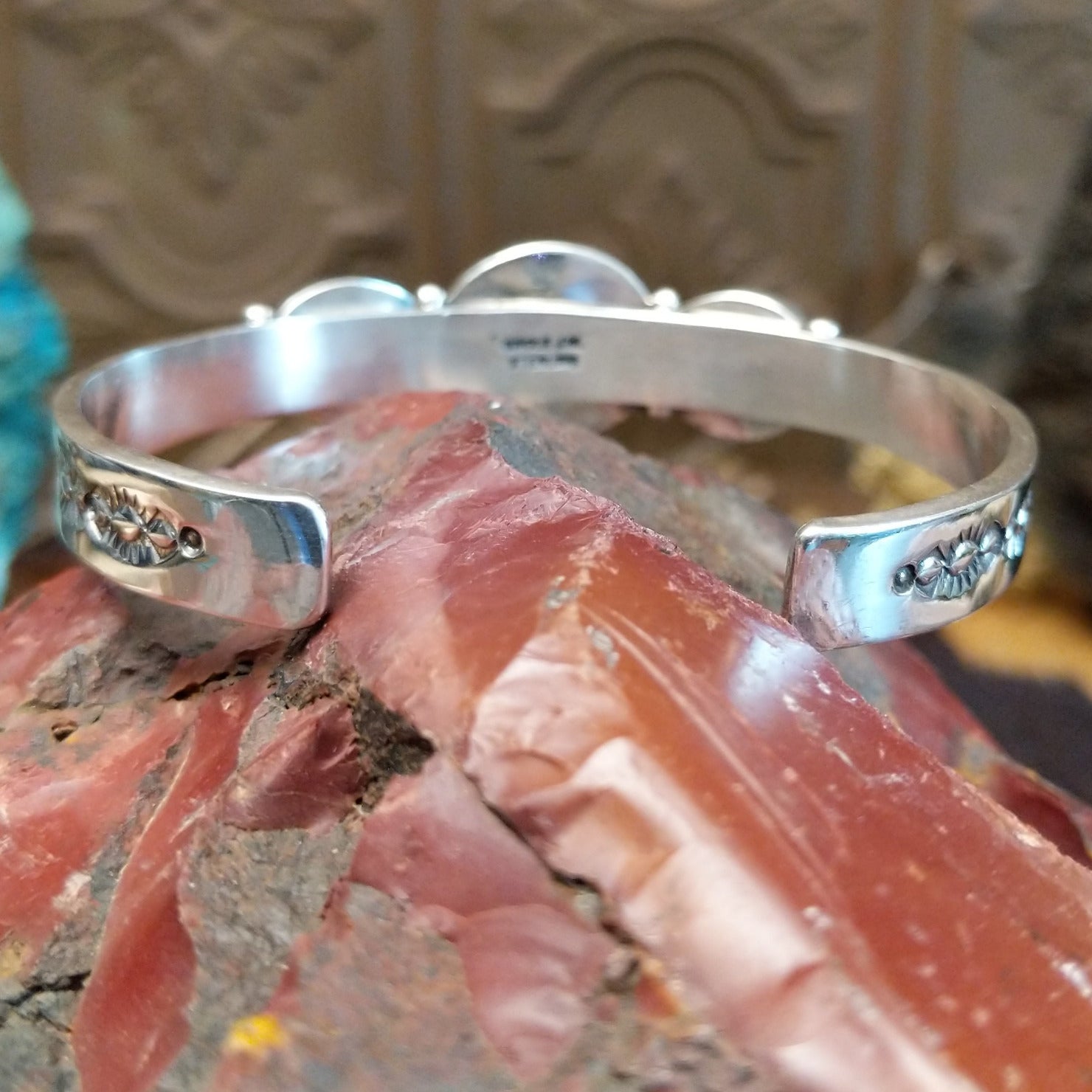 Sterling silver cuff with Sonoran gold turquoise set in oval bezels, framed by twisted rope and dotted accents.