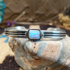 Sterling silver cuff with blue manmade opal set in a square bezel and layered band.