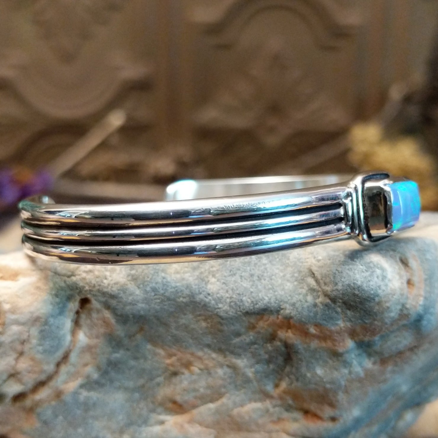 Sterling silver cuff with blue manmade opal set in a square bezel and layered band.