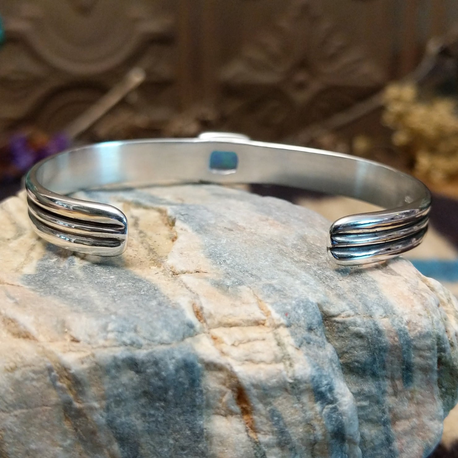 Sterling silver cuff with blue manmade opal set in a square bezel and layered band.