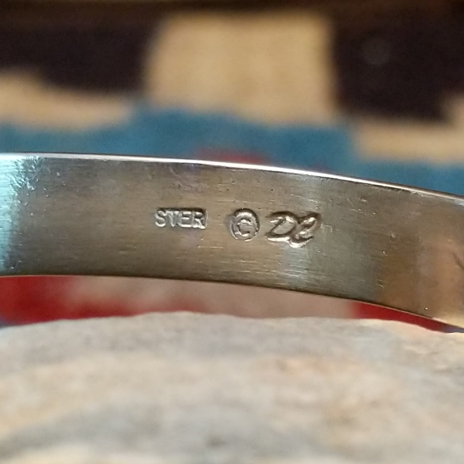 Close-up of the artisan's stamped signature.