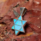 Sterling silver Star of David pendant with blue manmade opal inlaid.