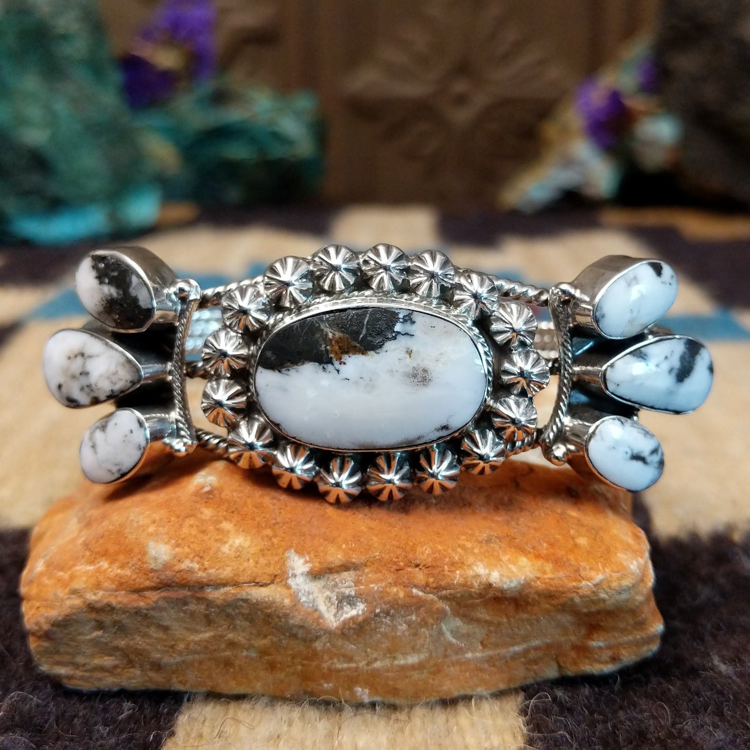 Navajo Starry White Buffalo cuff, featuring a white buffalo stone with bold black matrix patterns set in handcrafted Southwestern-inspired metalwork.
