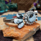 Navajo Starry White Buffalo cuff, featuring a white buffalo stone with bold black matrix patterns set in handcrafted Southwestern-inspired metalwork.  Side view.
