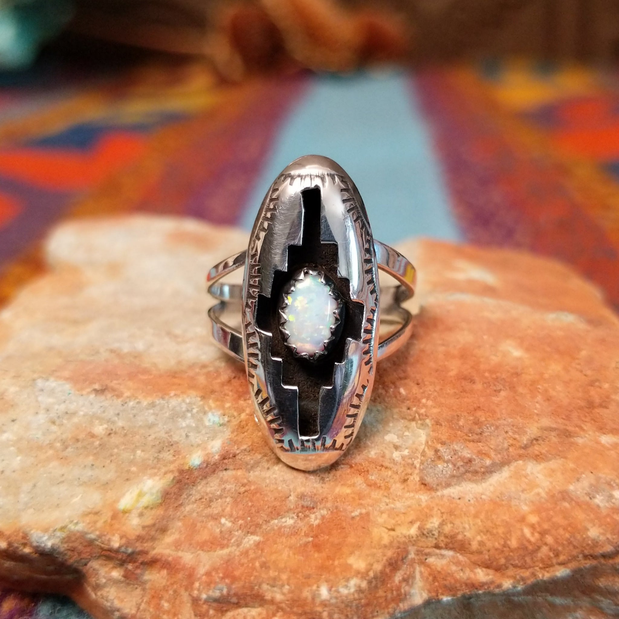Navajo silver shadowbox ring by P. with stepped design and manmade opal center.