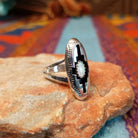 Navajo silver shadowbox ring by P. with stepped design and manmade opal center.