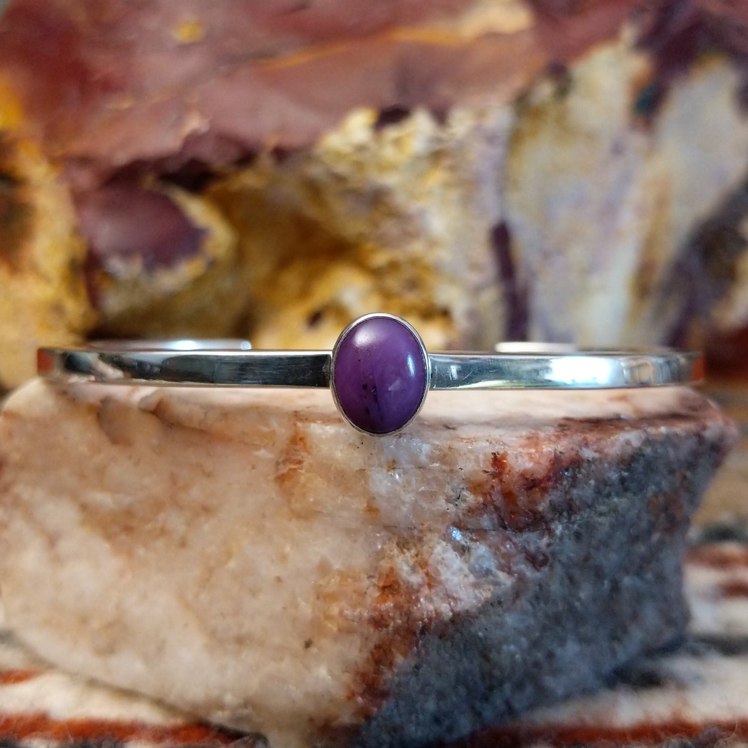 Thin sterling silver cuff with sugilite set in the bezel.