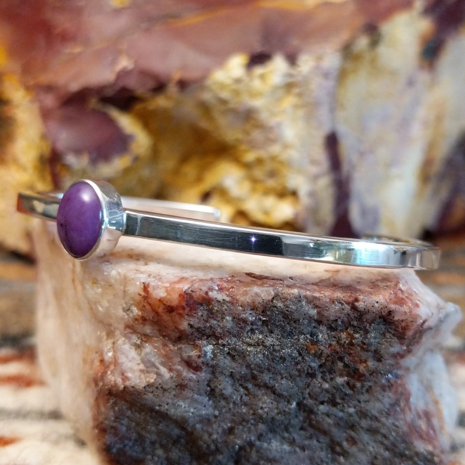 Thin sterling silver cuff with sugilite set in the bezel.
