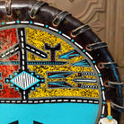 A close-up of the painted yellow design with various colorful motifs.
