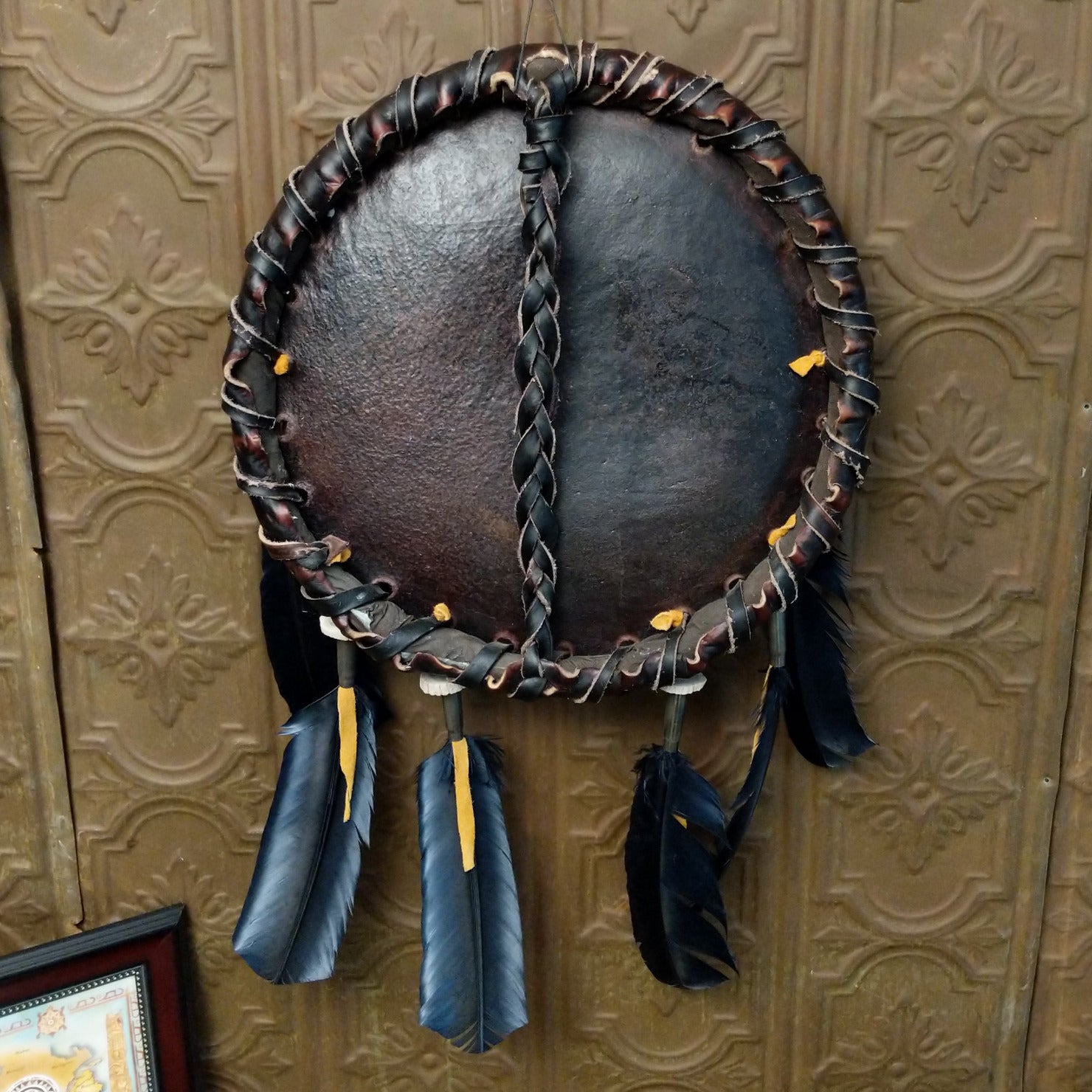 The back features the ties of the dark leather.