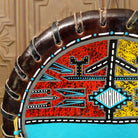 A close-up of the painted red design with various colorful motifs.