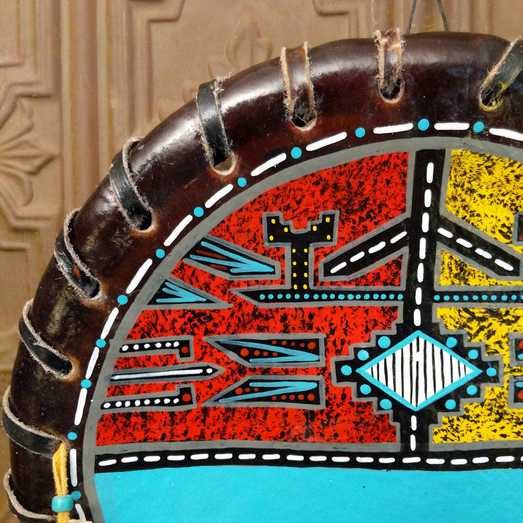 A close-up of the painted red design with various colorful motifs.