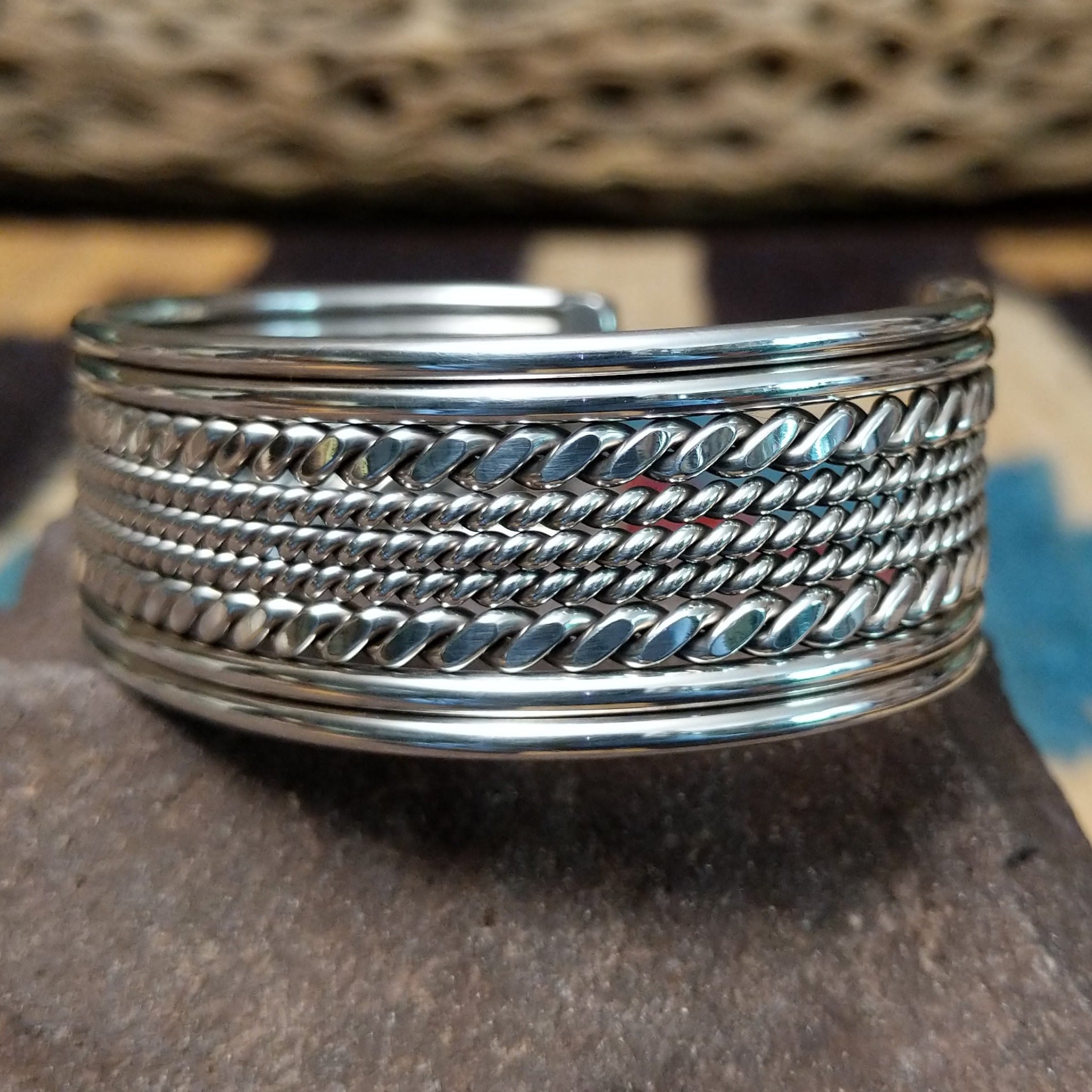Navajo suspended sterling silver cuff, featuring layered twisted rope and polished silver strands in a handcrafted open cuff design with traditional Southwestern craftsmanship.