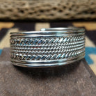 Navajo suspended sterling silver cuff, featuring layered twisted rope and polished silver strands in a handcrafted open cuff design with traditional Southwestern craftsmanship.