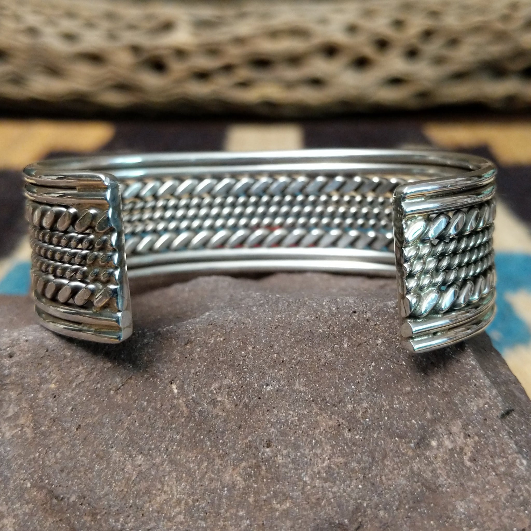 Navajo suspended sterling silver cuff, featuring layered twisted rope and polished silver strands in a handcrafted open cuff design with traditional Southwestern craftsmanship.  Underside view.