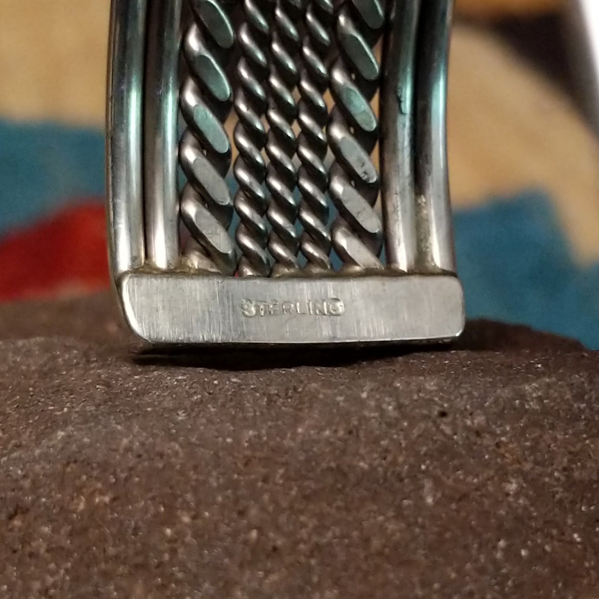 Navajo suspended sterling silver cuff, featuring layered twisted rope and polished silver strands in a handcrafted open cuff design with traditional Southwestern craftsmanship.  Sterling Silver stamp.