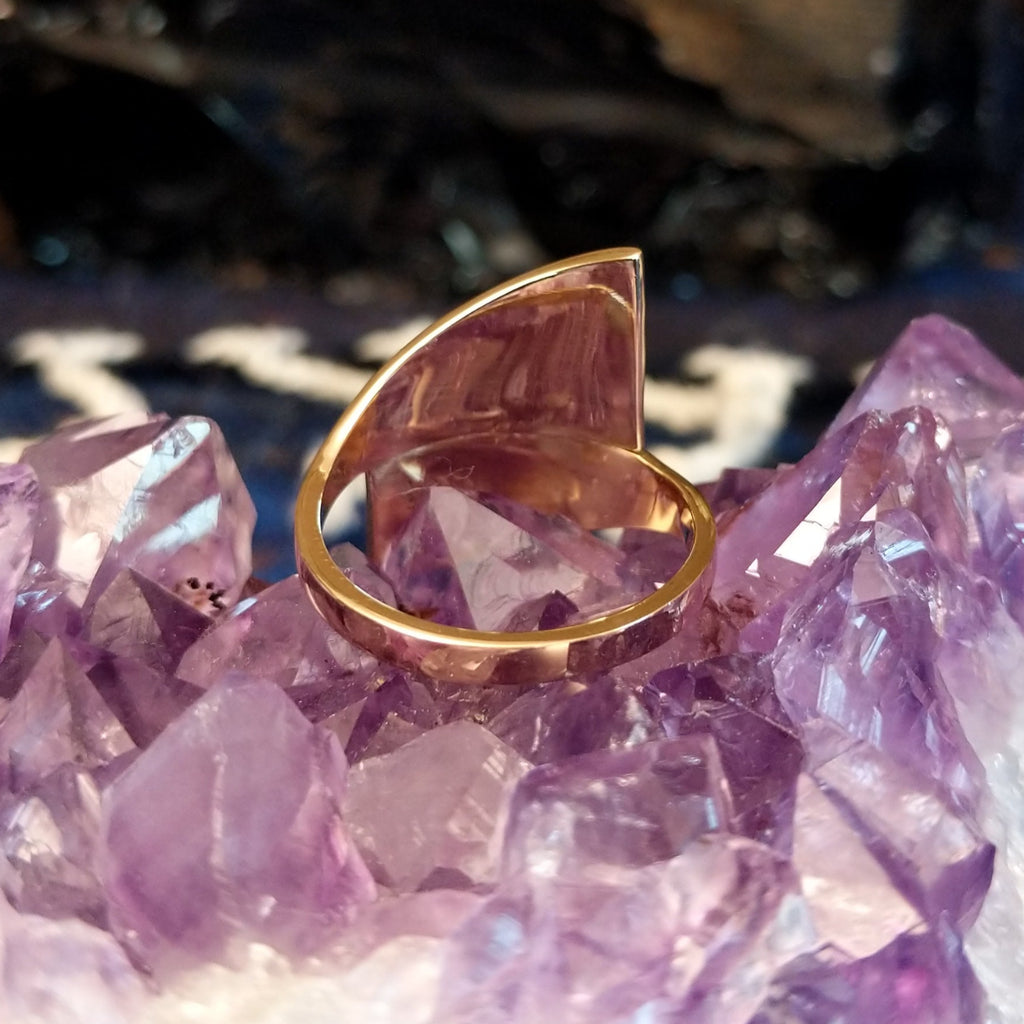 The polished gold band of the ring.