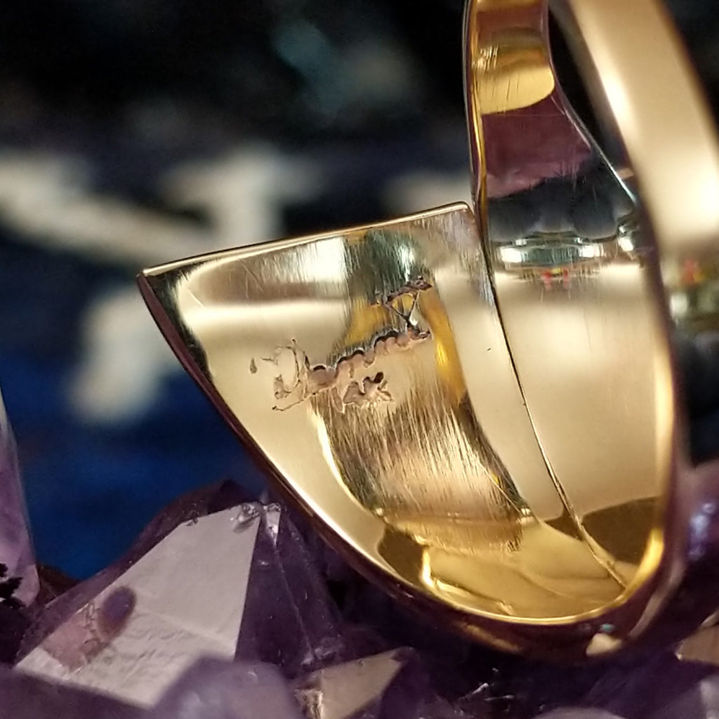 The maker's mark etched into the inside of the gold ring.