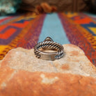 Navajo silver ring with triangular White Buffalo stone and double twisted band.