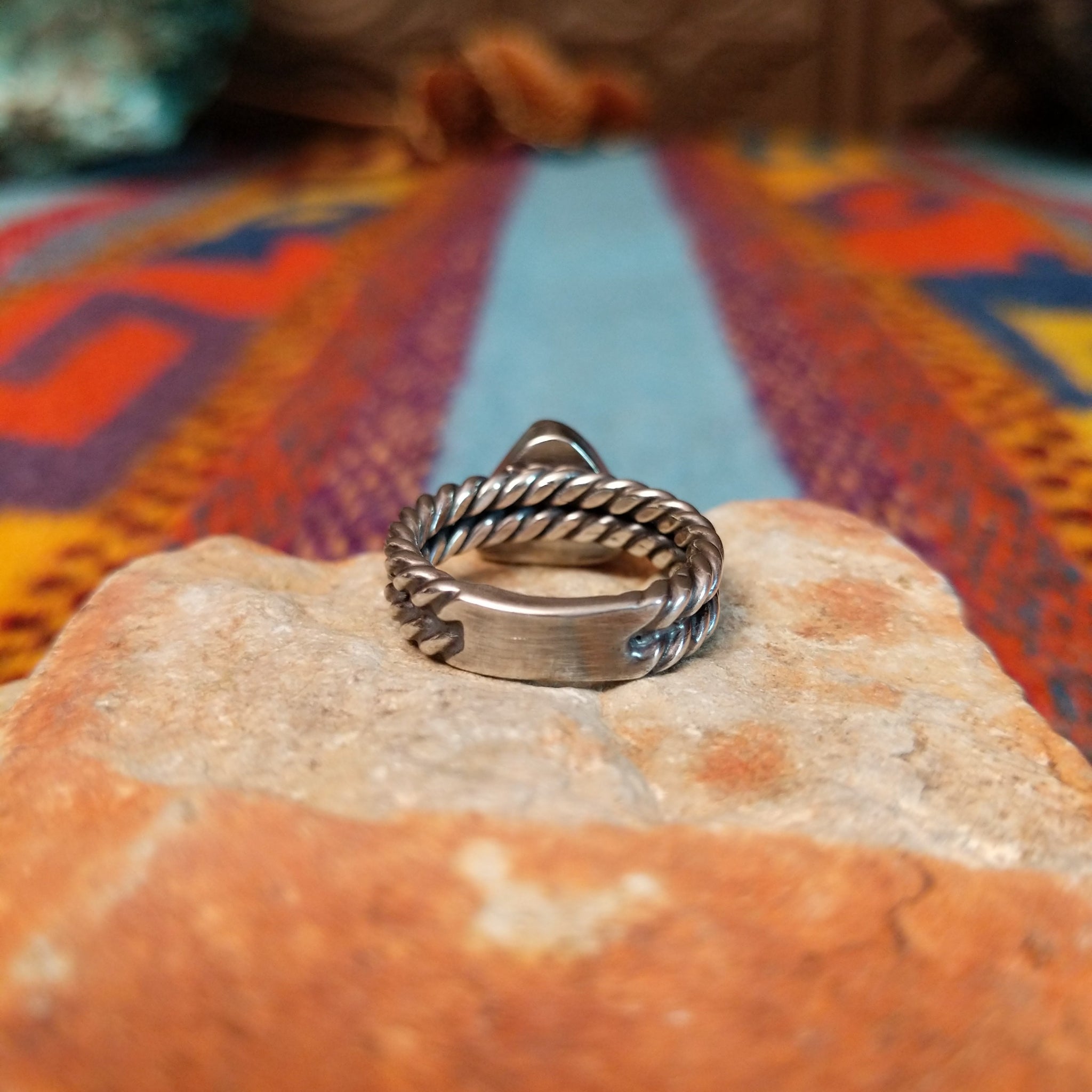Navajo silver ring with triangular White Buffalo stone and double twisted band.