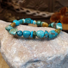 Bracelet with turquoise beaded along the elastic band.