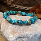Bracelet with turquoise beaded along the elastic band.