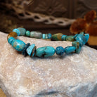 Bracelet with turquoise beaded along the elastic band.