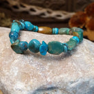 Bracelet with turquoise beaded along the elastic band.