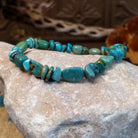 Bracelet with turquoise beaded along the elastic band.