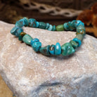 Bracelet with turquoise beaded along the elastic band.