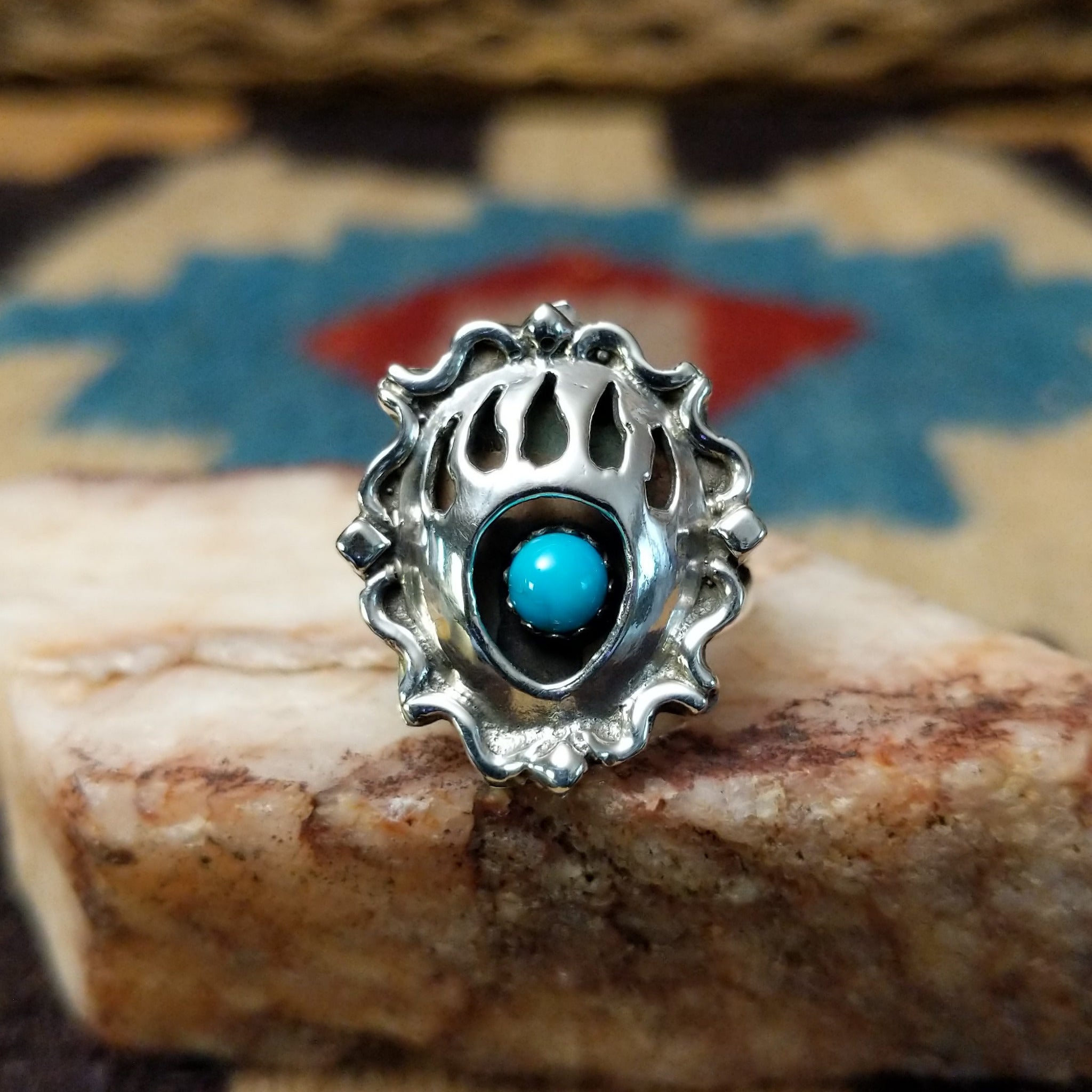 Navajo turquoise bear paw shadowbox ring, featuring a round blue turquoise stone set in a handcrafted sterling silver bear paw design with a dimensional shadowbox setting.