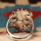 Navajo turquoise bear paw shadowbox ring, featuring a round blue turquoise stone set in a handcrafted sterling silver bear paw design with a dimensional shadowbox setting.  Sterling Silver stamp.