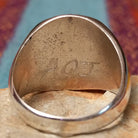 Navajo Turquoise Circle Ring by A.Q.J. featuring a large round turquoise stone with natural dark matrix, framed by twisted rope detailing and set in polished Sterling Silver; artisan initials.