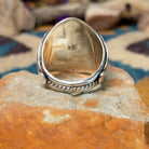 Sterling silver Navajo turquoise cluster ring featuring seven turquoise cabochons, serrated bezels, silver raindrop accents, and a classic Southwestern floral cluster design; underside view.