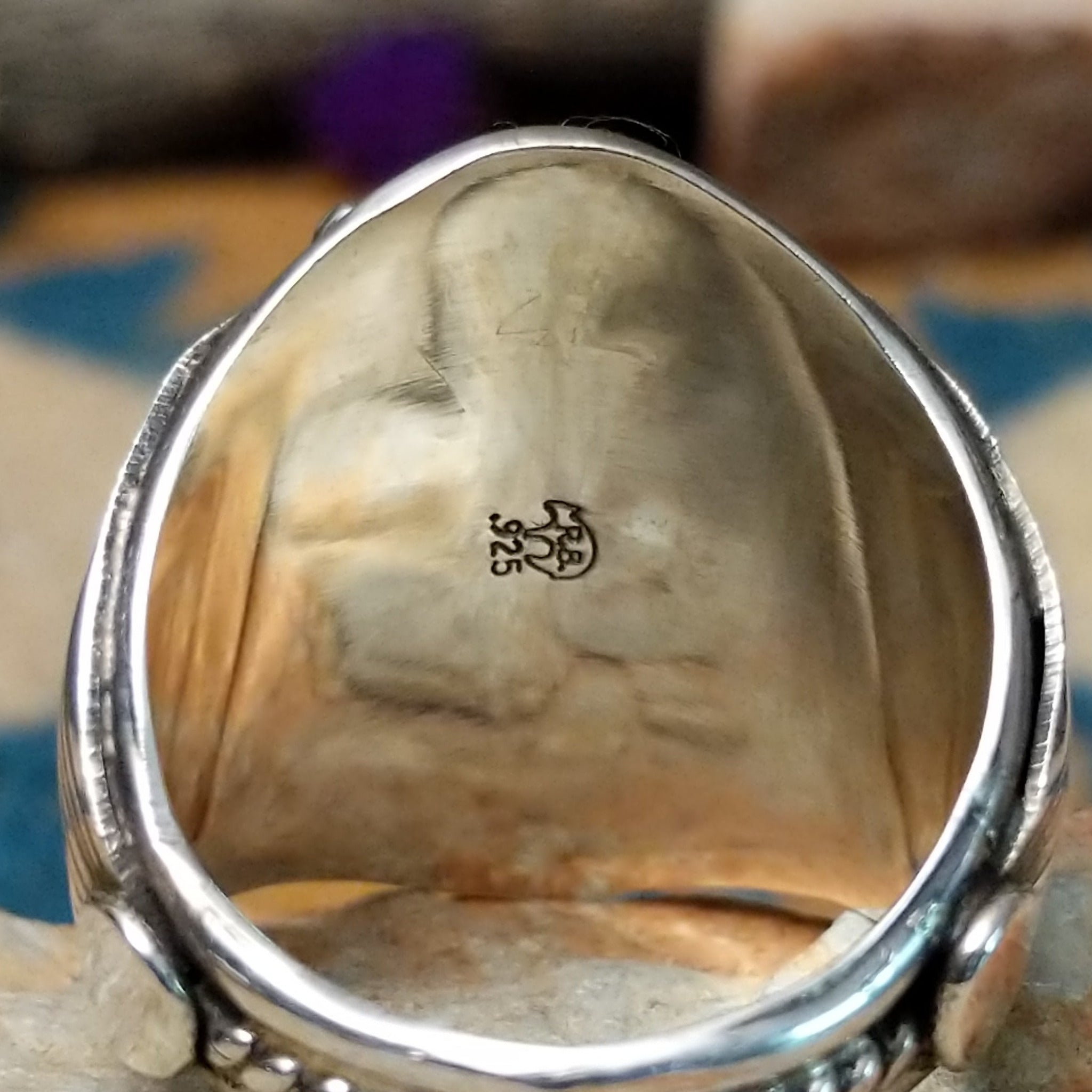 Sterling silver Navajo turquoise cluster ring featuring seven turquoise cabochons, serrated bezels, silver raindrop accents, and a classic Southwestern floral cluster design; artisan and .925 (Sterling Silver) stamp.