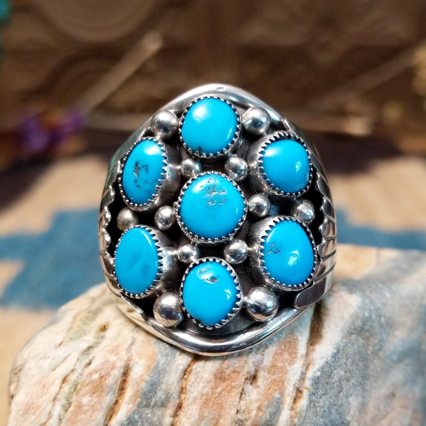 Sterling silver ring with turquoise set in clusters of notched bezels.