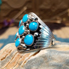 Sterling silver ring with turquoise set in clusters of notched bezels.