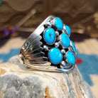 Sterling silver ring with turquoise set in clusters of notched bezels.