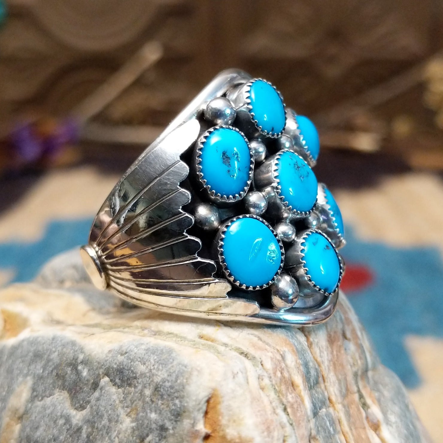 Sterling silver ring with turquoise set in clusters of notched bezels.
