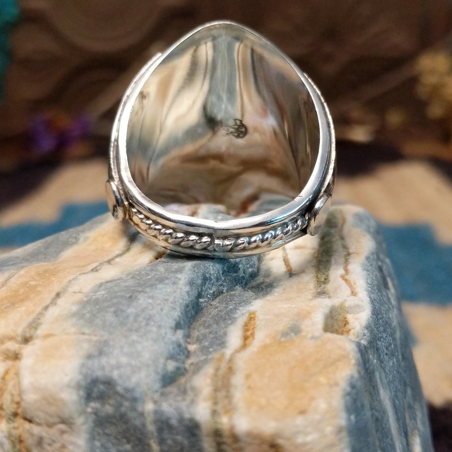 Sterling silver ring with turquoise set in clusters of notched bezels.