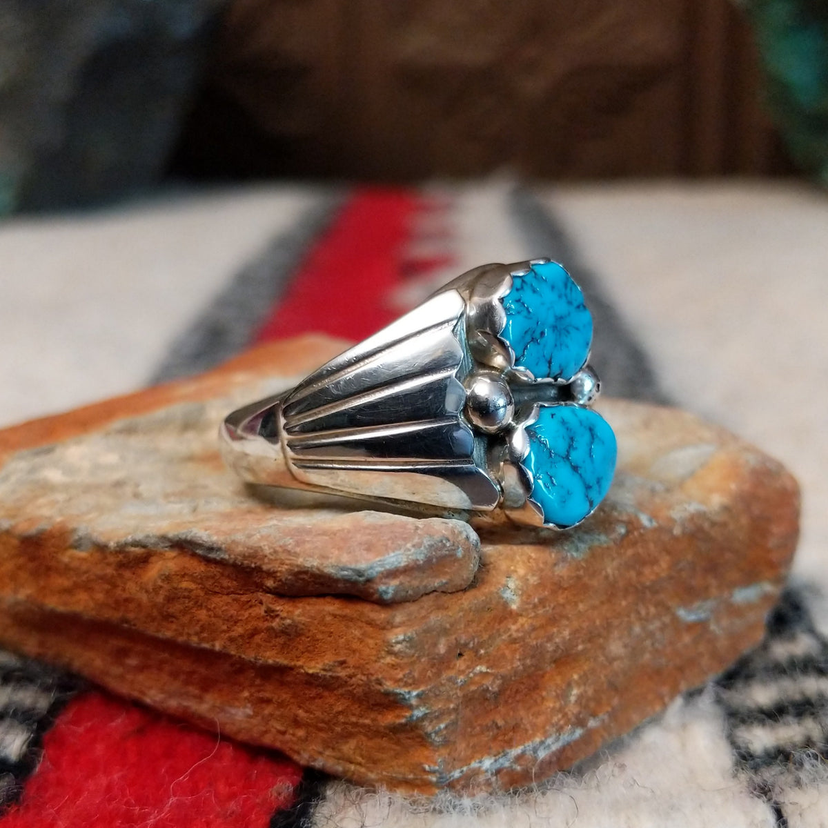 Navajo Turquoise Duo Ring by S. featuring two bright blue turquoise stones with dark matrix, silver bead accents, and a wide detailed silver band; side view.