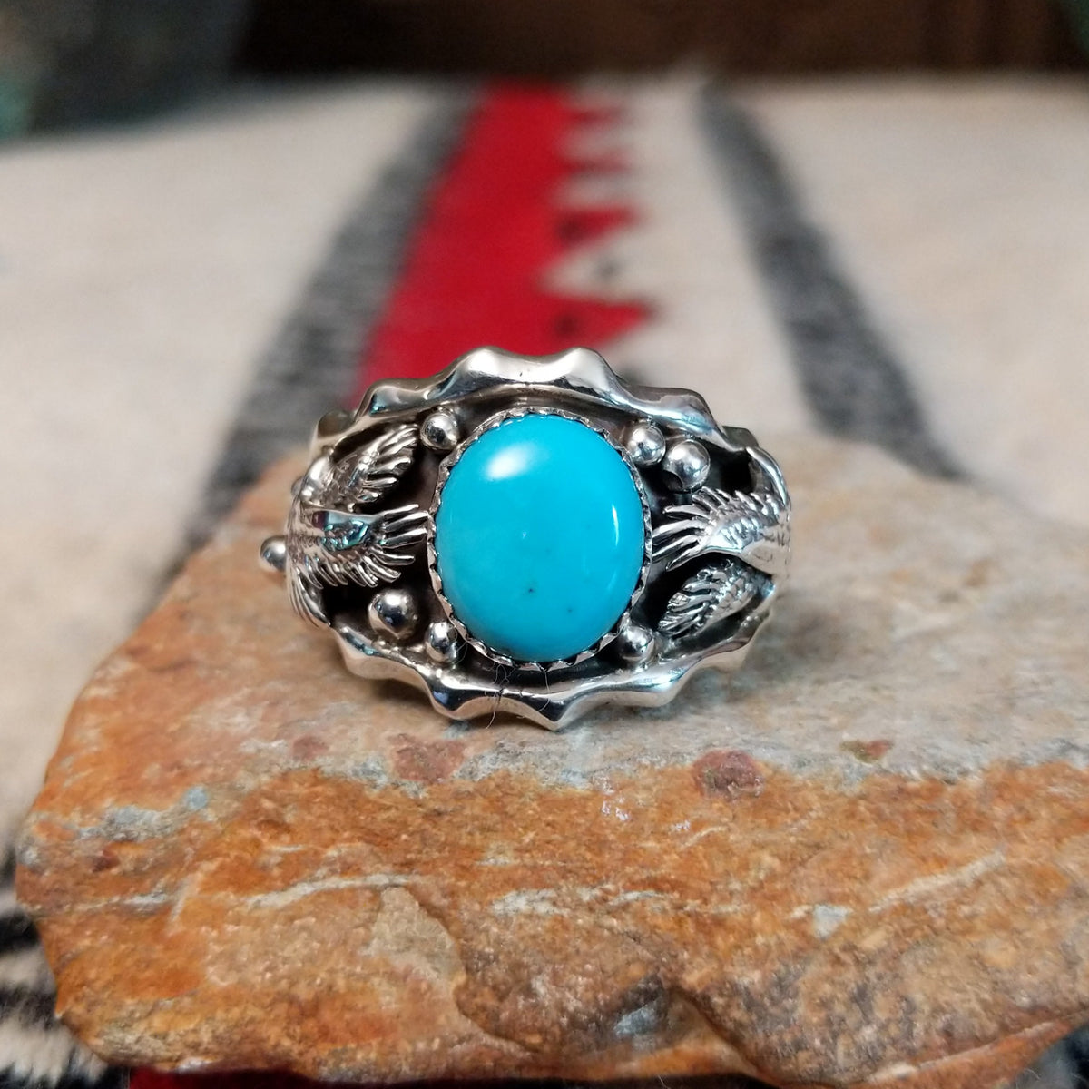 Navajo turquoise silver ring with dimensional eagle design.