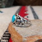 Navajo turquoise silver ring with dimensional eagle design.
