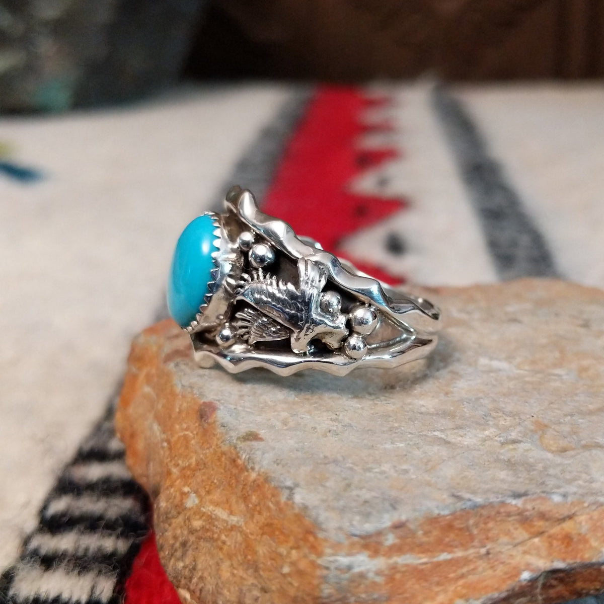 Navajo turquoise silver ring with dimensional eagle design.