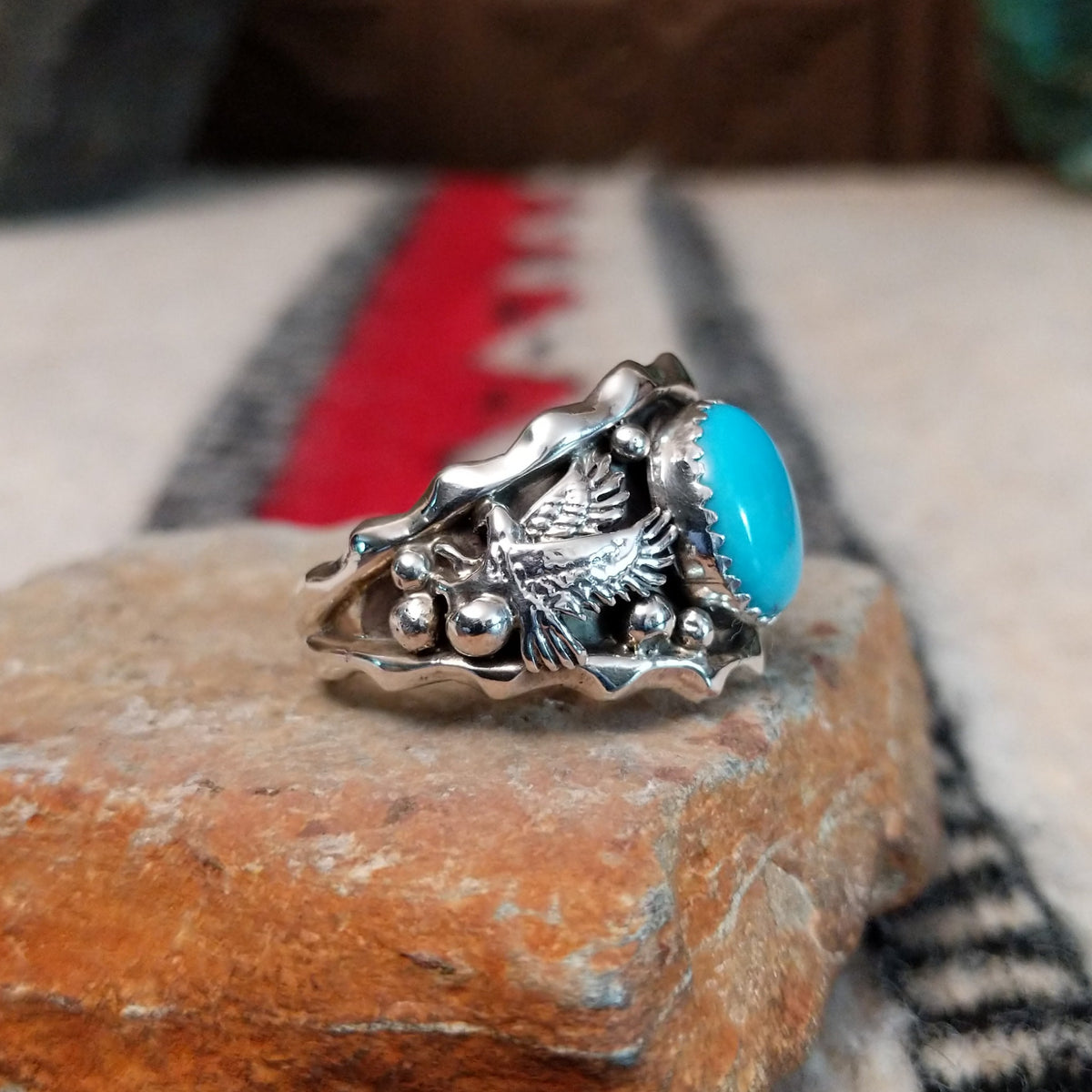 Navajo turquoise silver ring with dimensional eagle design.