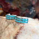 Sterling silver half hoop earrings with inlaid turquoise.