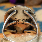 Sterling silver Navajo turquoise ring by J.M.N. with an oval sky-blue stone and hand-stamped horn design; artisan and Sterling Silver stamp.