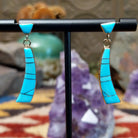 14kt gold Navajo dangle earrings with curved turquoise inlay panels.