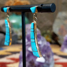 14kt gold Navajo dangle earrings with curved turquoise inlay panels.