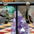 Close up of earring backing and stamped 14K indicating 14 karat gold construction.